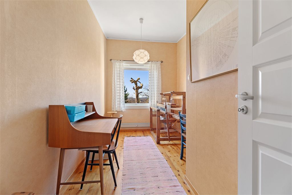 Lyst soverom med tregulv og vindu