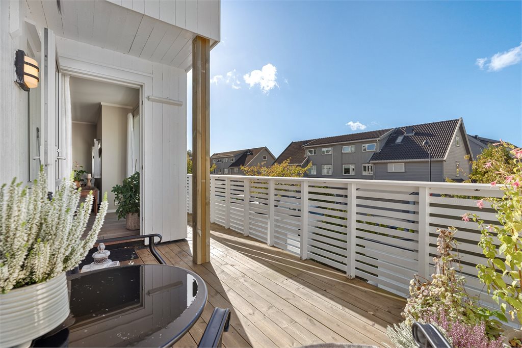 Veranda med utgang fra stue med utsikt over fellesområder. Her har man kveldssol til ca 20:30 midtsommertid
