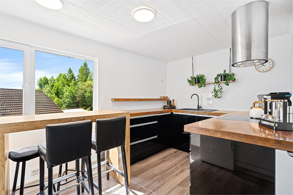 Kjøkken med barløsning og utsikt mot grøntområde
